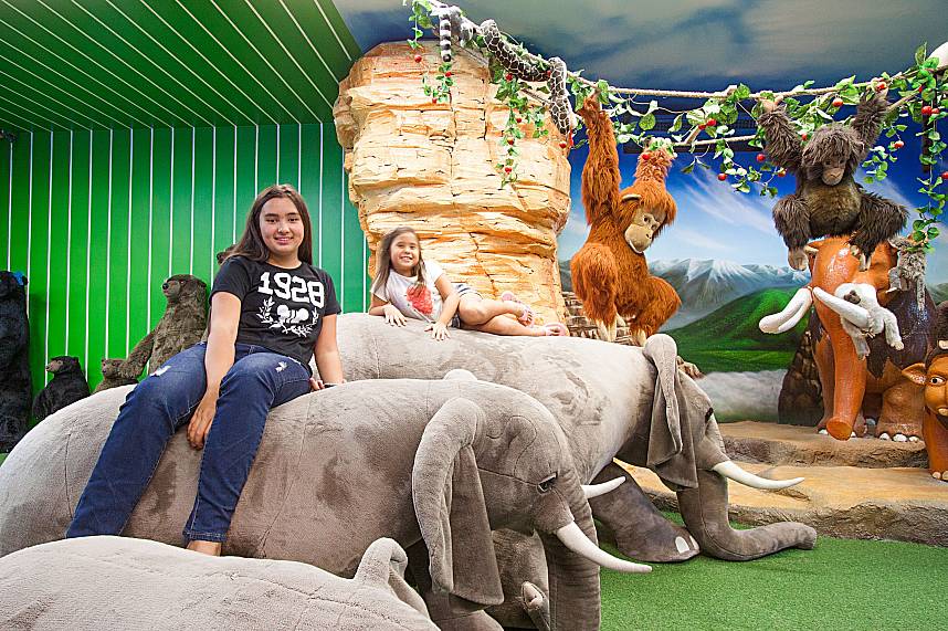 Kids enjoy themselves on the back of huge animated elephants at Pattaya Teddy Bear Museum