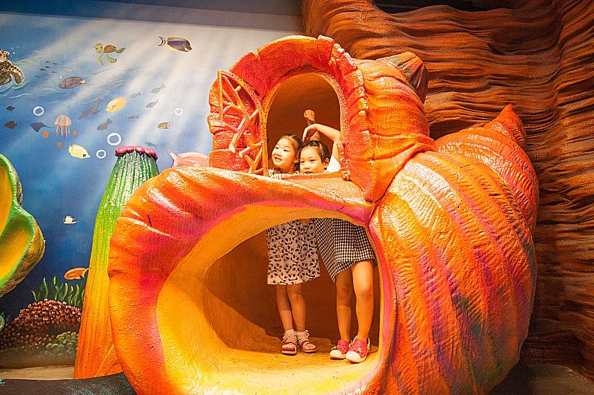 Kids have lots of fun inside a fish sculpture at Pattaya Teddy Bear Museum