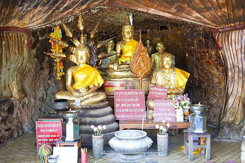 With gold leaves covered Buddhas at a temple on Koh Loy Tropical Island, Pattaya