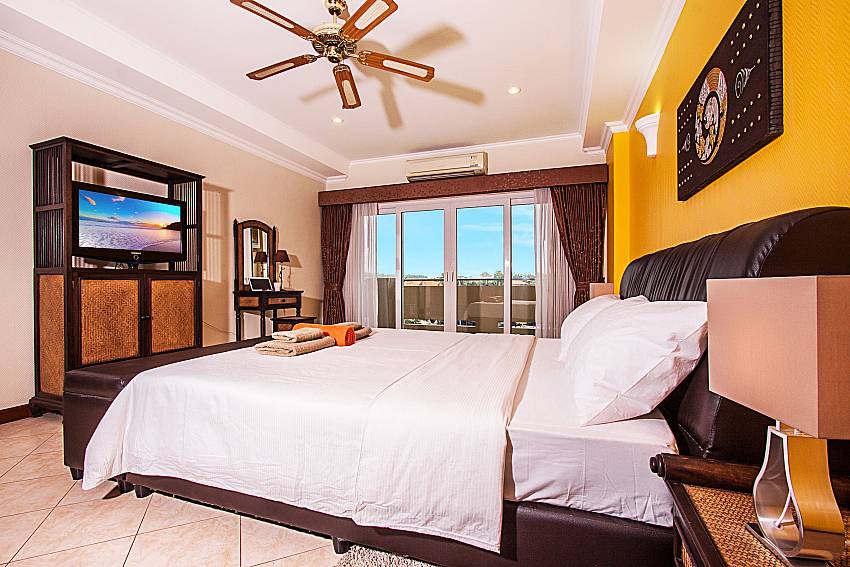Bedrooms are furnished with a TV and a fan bedroom of Sirinda Residence No.25