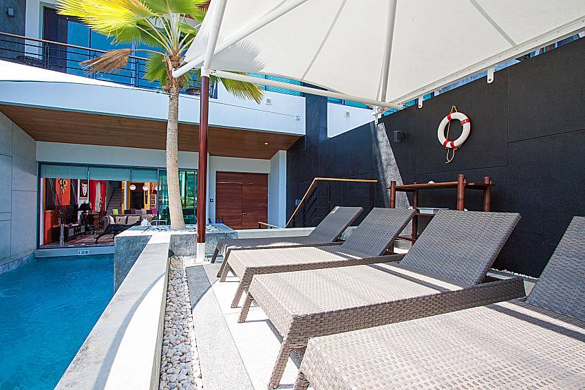 Sun bed near swimming pool Un-Chan Villa in Phuket 