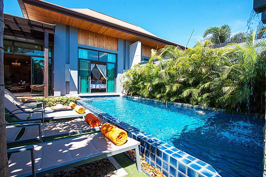 Sun bed near swimming pool and property Preuk Sah Villa in Phuket
