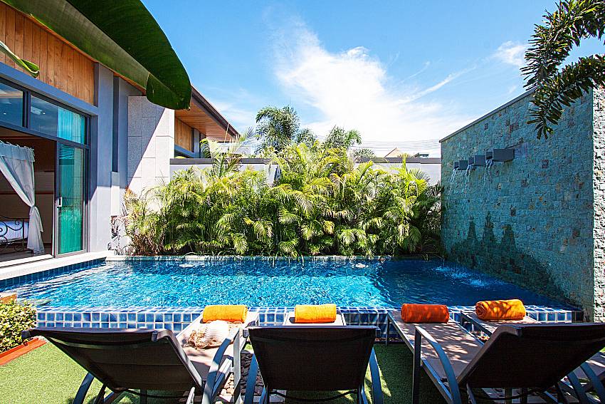 Sun bed near swimming pool Preuk Sah Villa in Phuket 