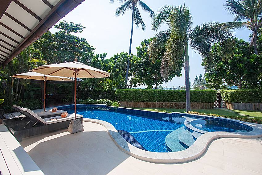 Sun bed near swimming pool and property Blossom Dew Villa B in Samui 