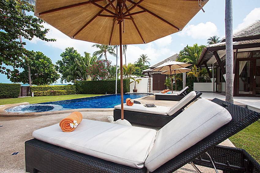 Sun bed near swimming pool and property Blossom Dew Villa C in Samui