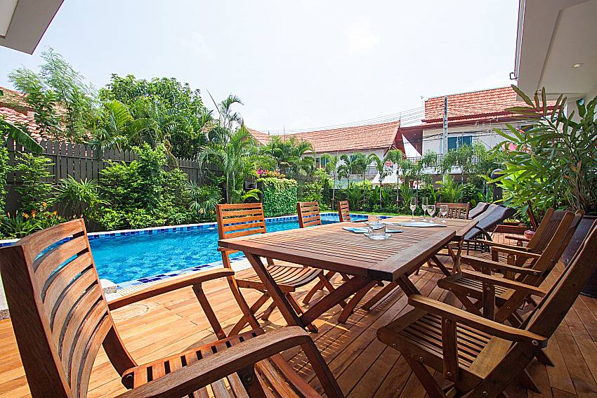 Seat and table near swimming pool City Haven Villa in Central Pattaya