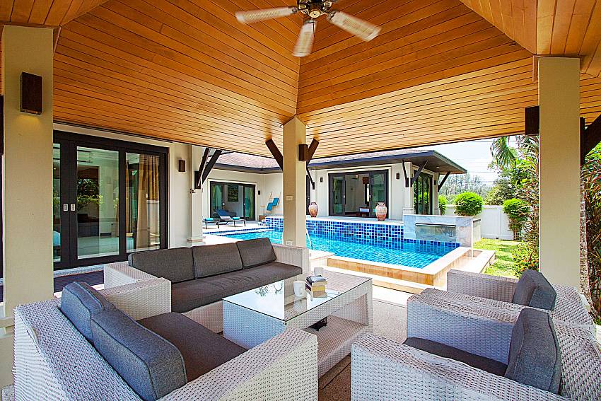 Sofa and table near swimming pool Villa Rachana in Phuket