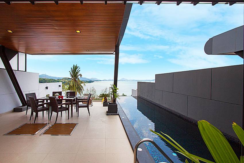 Seat and table near swimming pool Villa Yamuna in Phuket