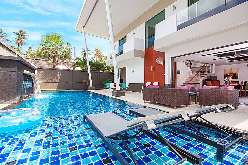 Sun bed near swimming pool and property Villa Elina in Phuket