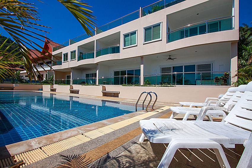 Sun bed near swimming pool and property Vara Apartment at Kata in Phuket  