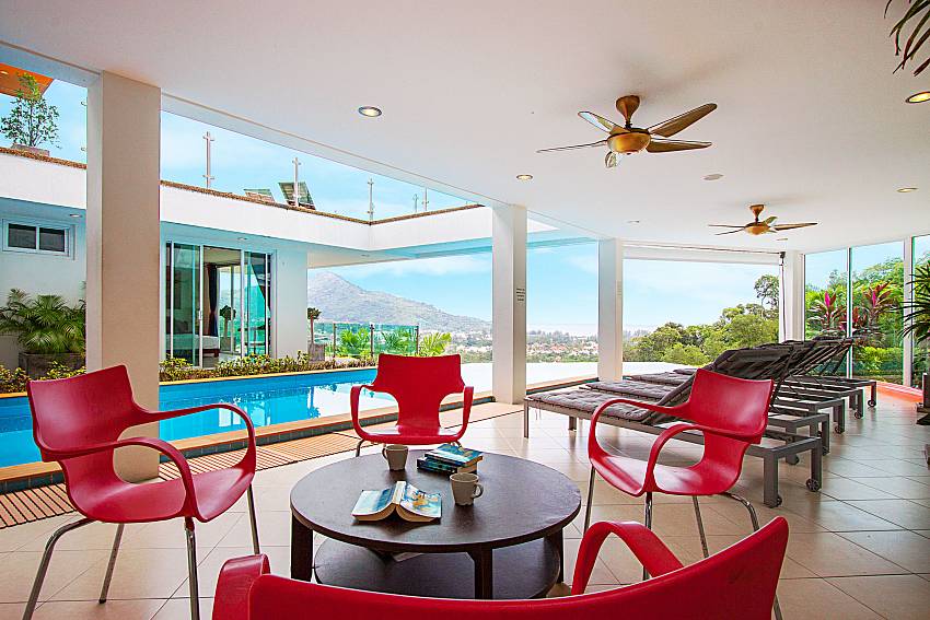 Seat and table near swimming pool Villa Niyati in Phuket