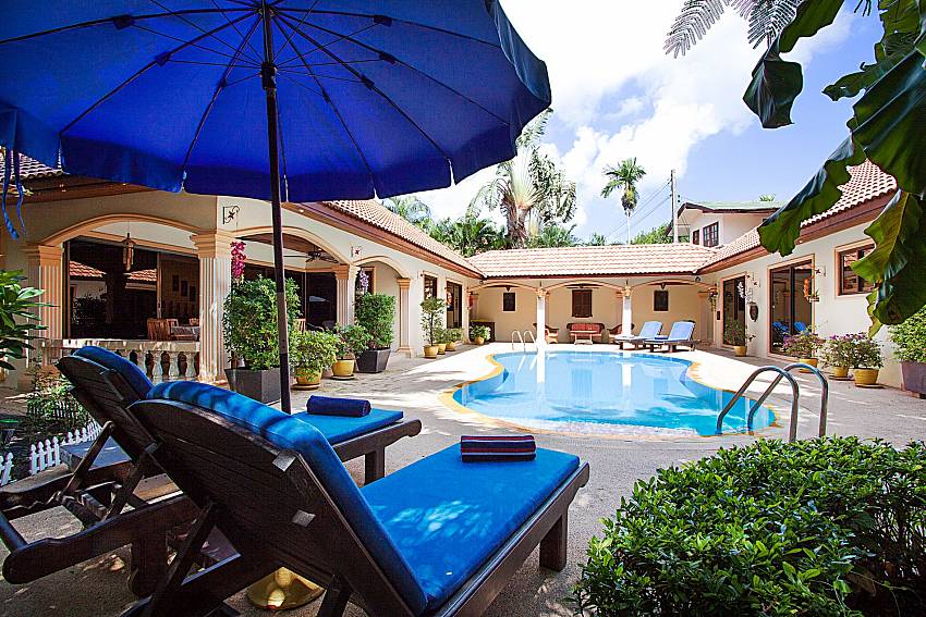 Sun bed near swimming pool and property Villa Oditi in Phuket