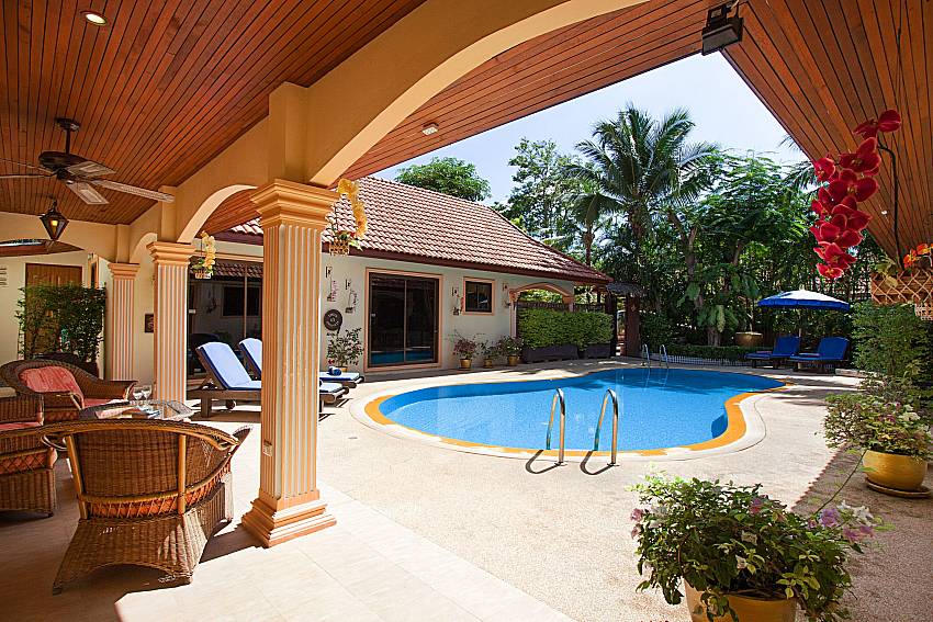 Seat and table near swimming pool Villa Oditi in Phuket