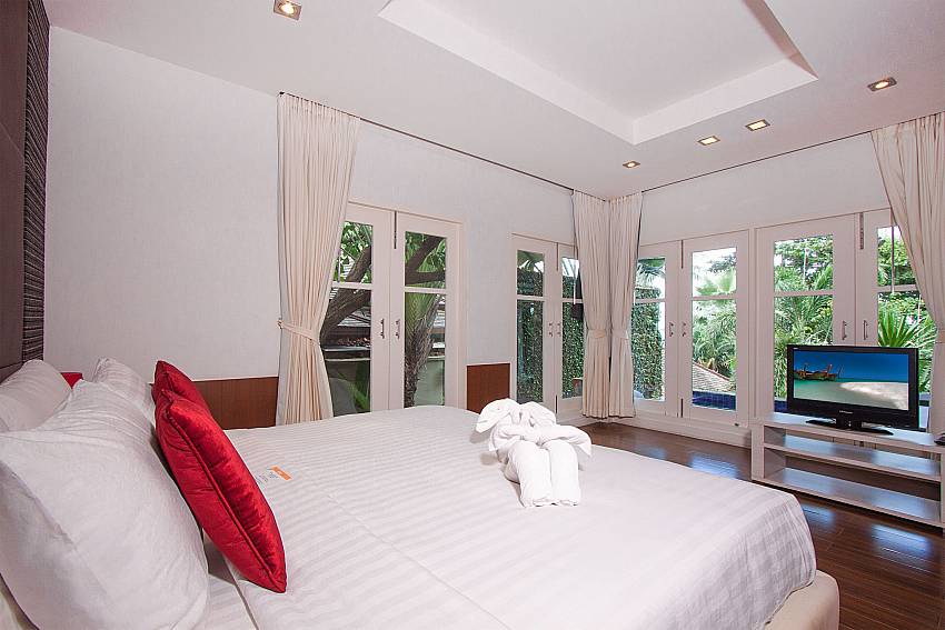 Double bedroom with TV and garden view at Villa Hutton 101 Samui Bo Phut