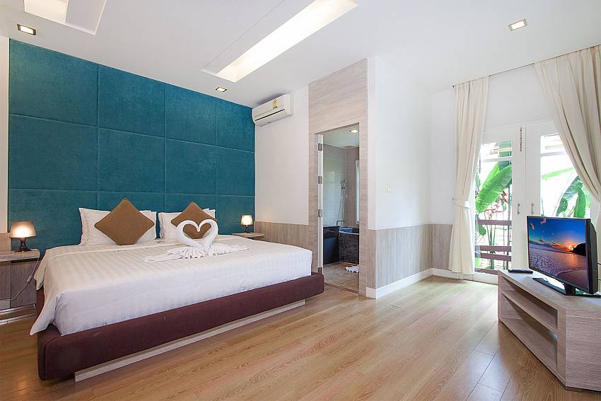 Master bedroom with TV and bathroom at Villa Hutton 202 Samui Bophut