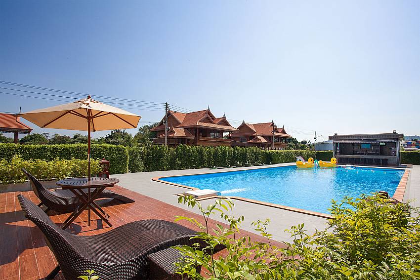 Sun bed near swimming pool Timberland Lanna Villa 302 in Bangsaray Pattaya