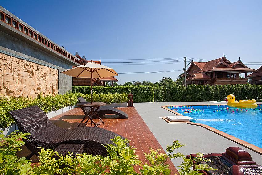 Sun bed near swimming pool Timberland Lanna Villa 401 in Pattaya