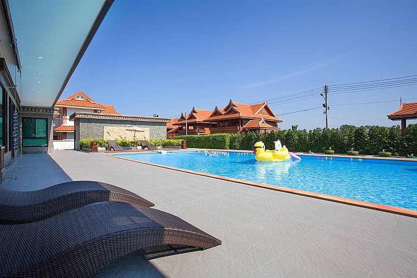 Sun bed near swimming pool Timberland Lanna Villa 403 in Pattaya
