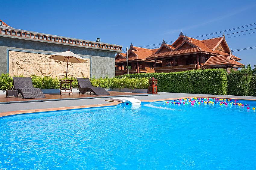 Sun bed near swimming pool Timberland Lanna Villa 404 in Pattaya