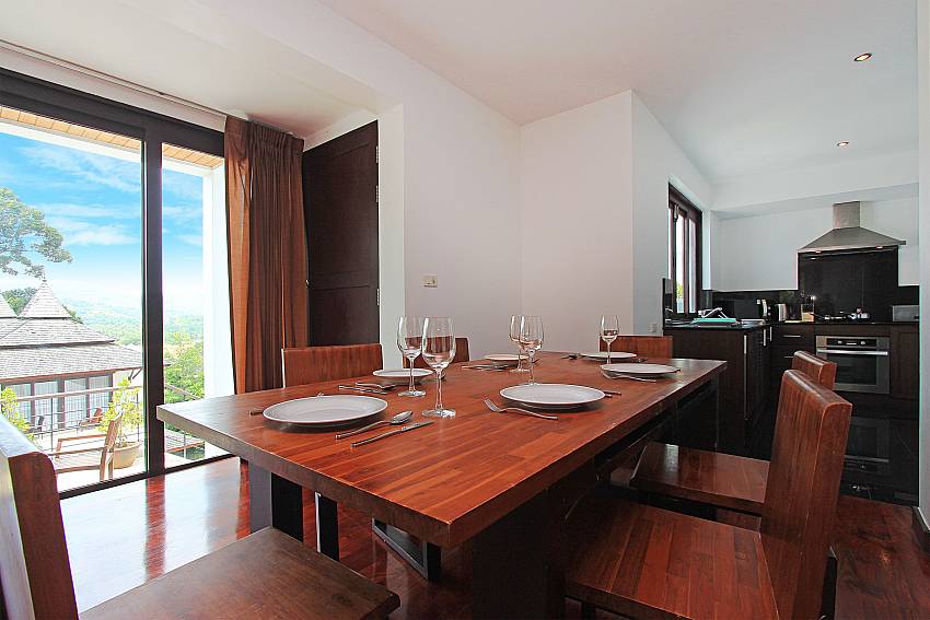 Dining table and kitchen of Nirano Villa 41 in Phuket