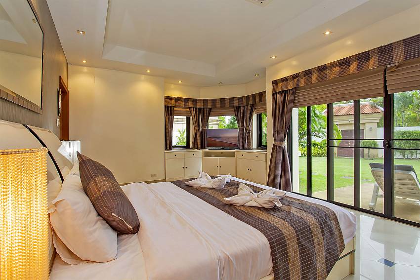 bedroom with double bed and garden access at Pattaya Presidential Villa