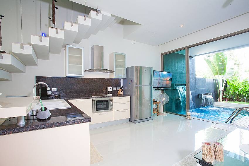 Open plan kitchen with living area and pool view in Friendship Villa No.7 Phuket