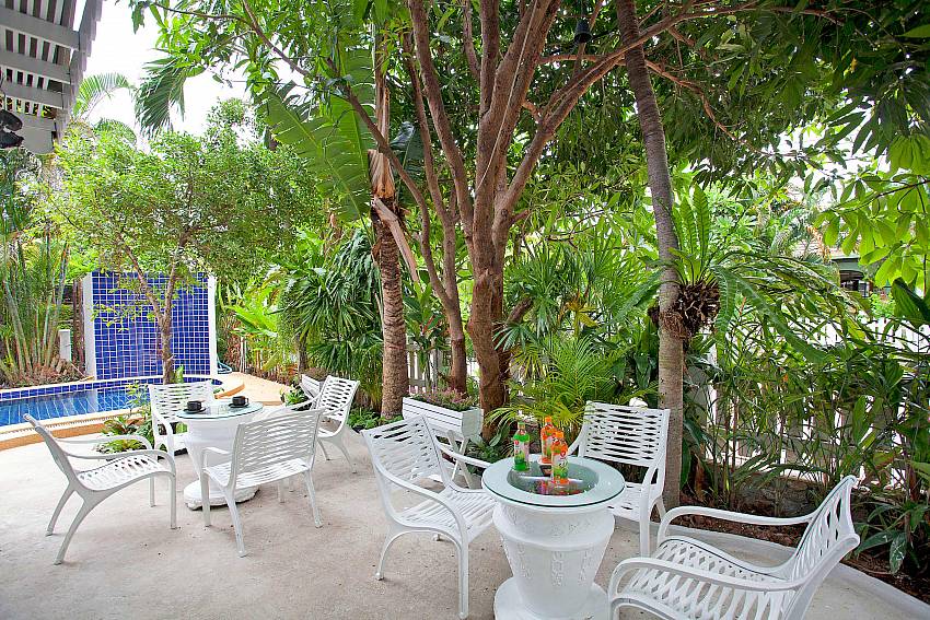 Coffee table outdoor near the trees Of Jomtien Paradise Villa