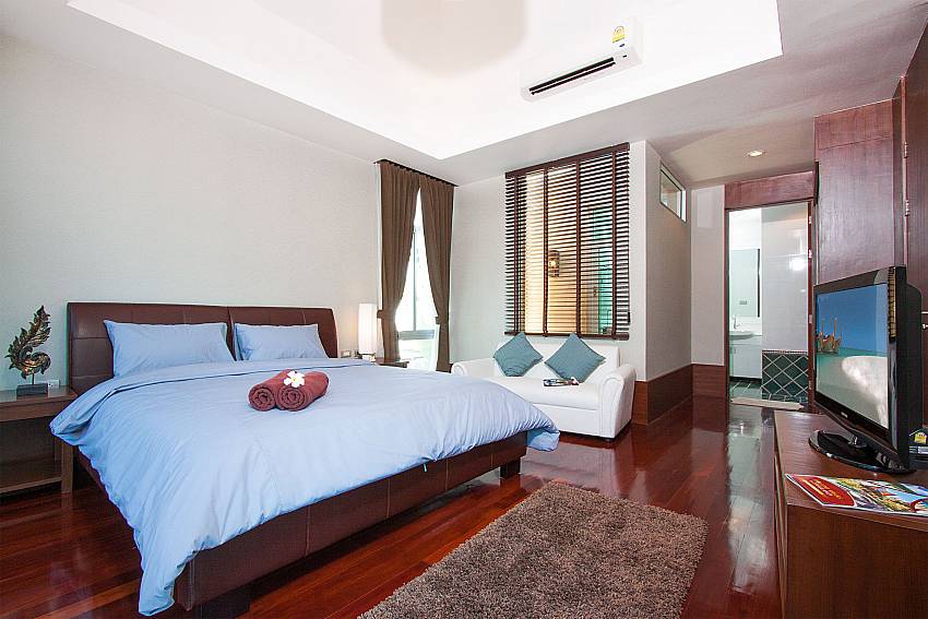1. king size bedroom with TV and sofa at Jomtien Waree 4 South Pattaya