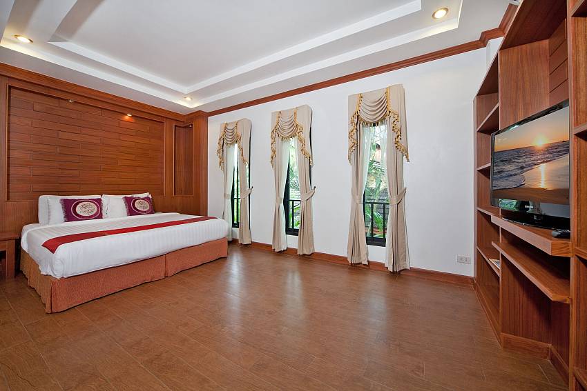 Bedroom views with TV and shelves Of BangTao Tara Villa 3 (First)