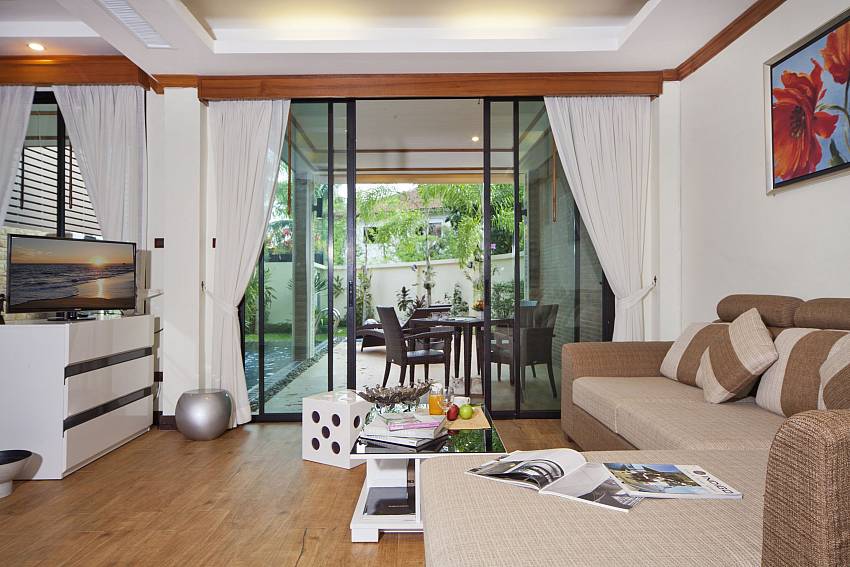 Living room with TV overlooking outside Of BangTao Tara Villa 4
