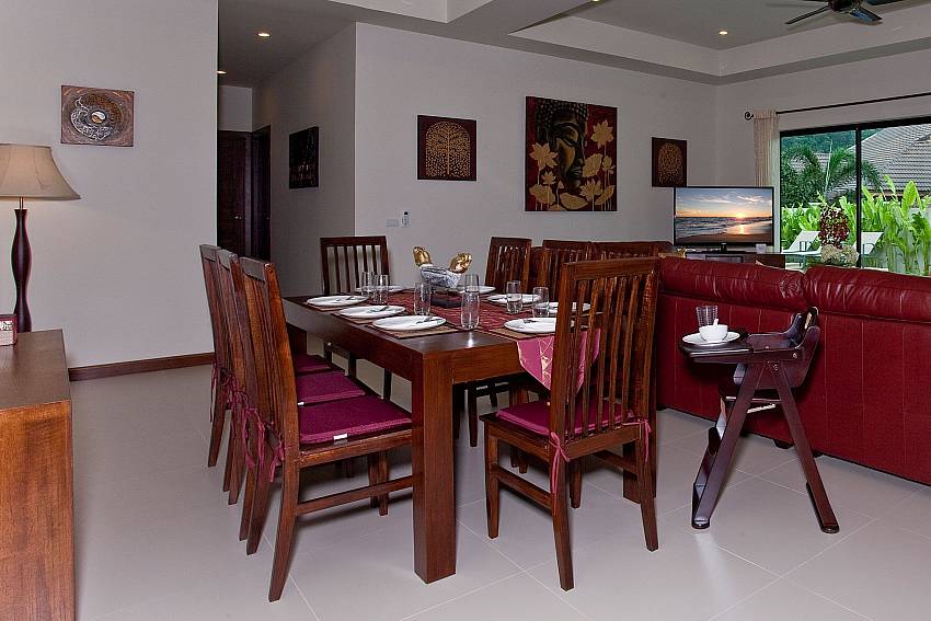 8 seating dining table with living area at Tub Tim Villa in Nai Harn Phuket