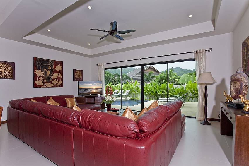 Comfortable lounge with pool view and TV at Tub Tim Villa in Phuket