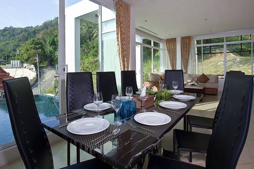 Dinning table overlooking the pool Of Kata Horizon Villa B2