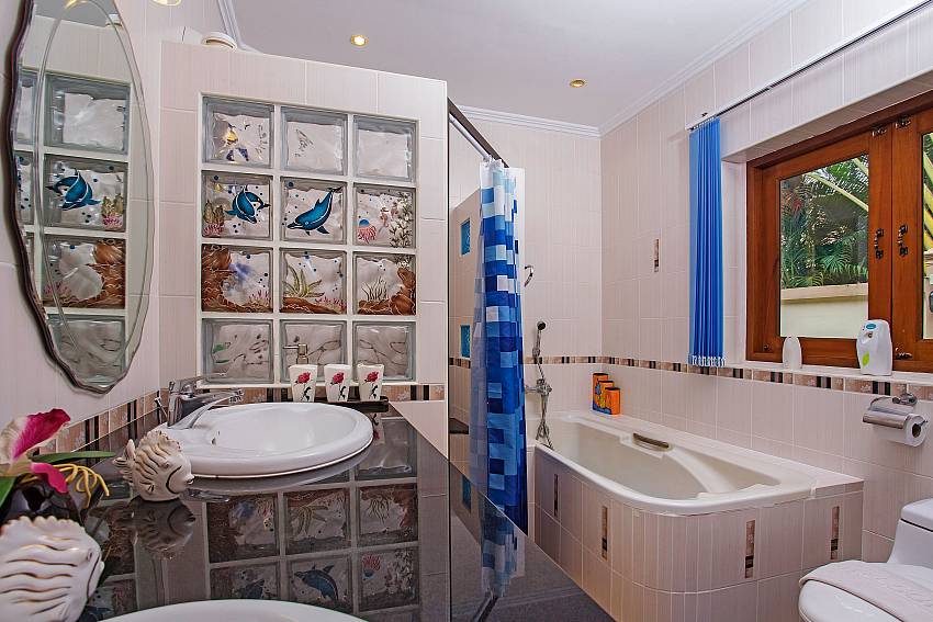 Bathroom with jacuzzi tub and toilet Of Relaxing Palms Pool Villa