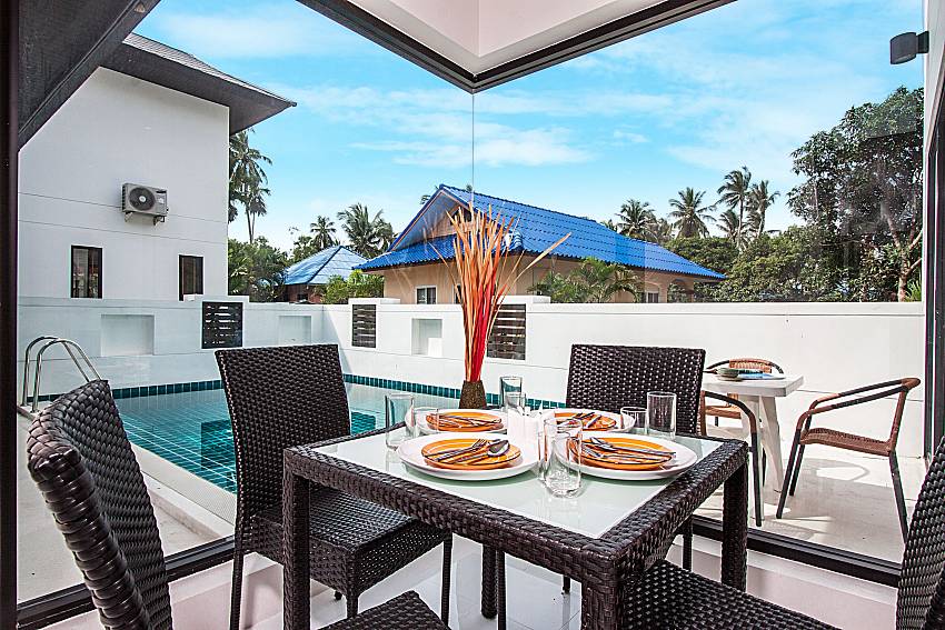 A small dinning table near the pool of Banthai Villa 13