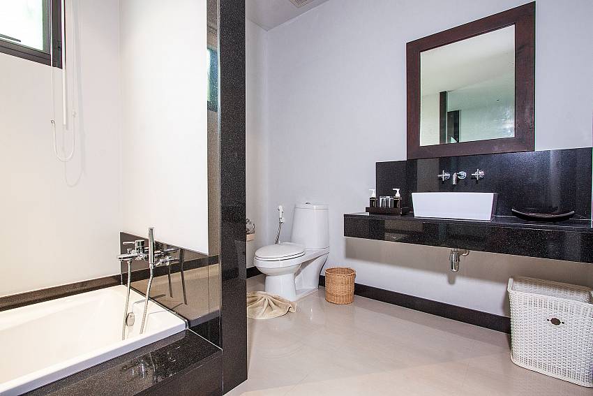 Toilet with basin and jacuzzi tub of Anon Villa